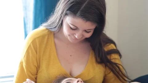 Tilt down of affectionate lesbian couple relaxing on bed Stock Footage 114861078