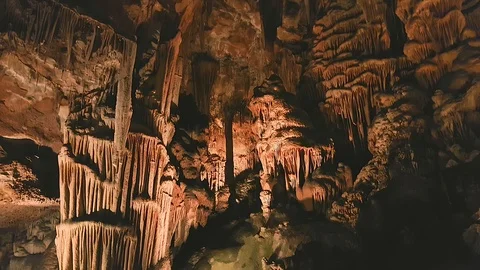 Tilt down ancient rock formation drapes on the wall of Saeva Cave, Bulgaria Stock Footage 86334591