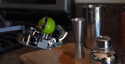 Tilt Down Of A Bartending Robotic Hand Holding A Lemon Stock Footage 248090158