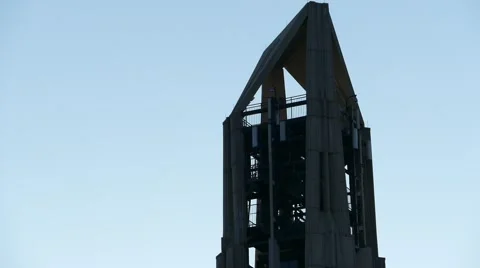 Tilt down from bell tower to a field of American flags on Veterans Day Video stock 56981772