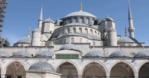 Tilt down from Blue Mosque domes to crowded courtyard fountain, Istanbul. Stock Footage 321047382