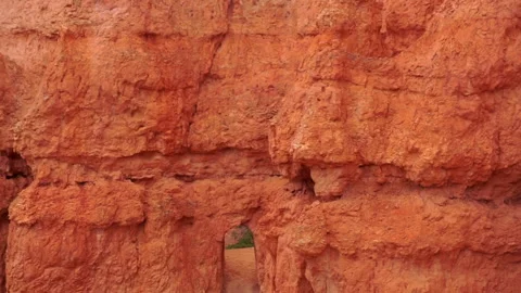 Tilt down from Bryce Canyon rock formations to rock passage way on trail. Stock Footage 138607981