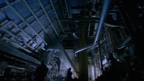 Tilt down from ceiling to floor of the inside of a factory Stock Footage 312274119