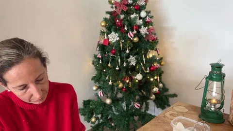 Tilt down from Christmas tree to cookie baking Stock Footage 340764256