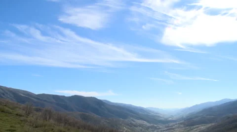 Tilt down from clouds to valley of fruit plantations Stock Footage 49653037