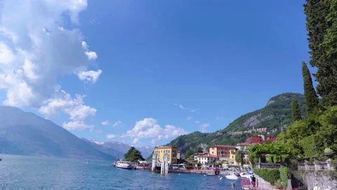 Tilt down from cloudy sky to ferry docks of italian village at Lake Como Stock Footage 277275220