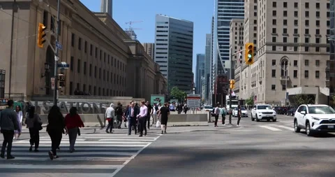 Tilt down from CN Tower to Union Station crosswalk in downtown Toronto Stock Footage 321035643