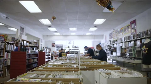 Tilt Down comic book boxes store slow motion 4K Stock Footage 171973989