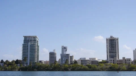 Tilt-down Condado lagoon aparment buildings skyline - cityscape Stock Footage 49687097