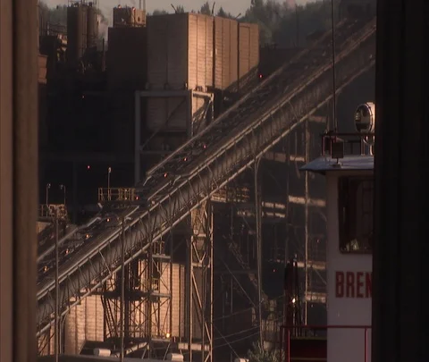 Tilt down from conveyor to coal car filled with coal at American Century Mine Stock Footage 86695040