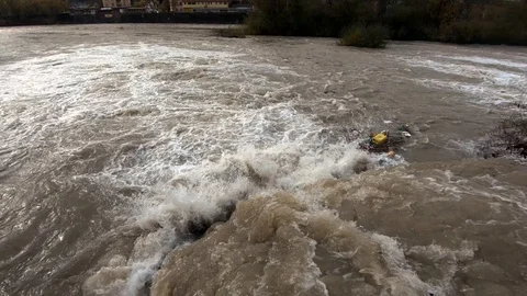 Tilt down dirty rainfall water leaving small concrete canal Video stock 120354300