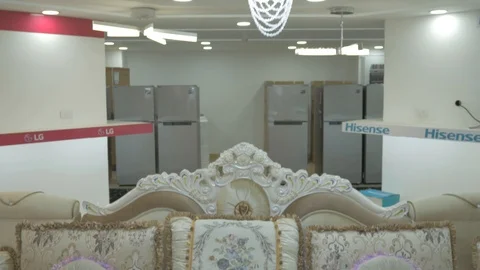 Tilt down display of Luxurious sofa with pillows and a refrigerator behind it. Stock Footage 97564208