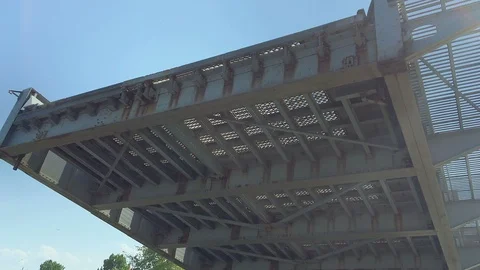 Tilt Down of Drawbridge Lowering Reveals Traffic Barriers with Blinking Lights Stock Footage 91636930