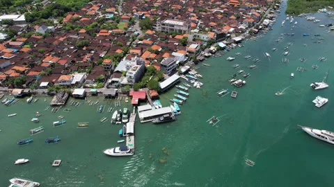 Tilt down drone shot of Serangan district and boats in Keramba Wayan Apel Str Stock Footage 285099663