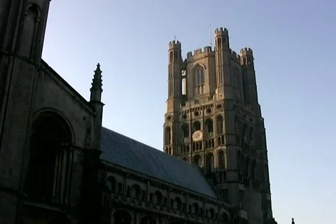 Tilt down from Ely Cathedral steeple to church yard Stock Footage 992118