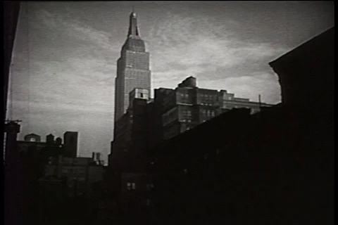 Tilt down Empire State building to New York City street, 1940s Stock Footage 90727539