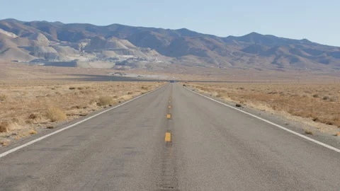 Tilt Down to Empty Desert Highway Leading to Modern Strip Mining Operation Stock Footage 144245257