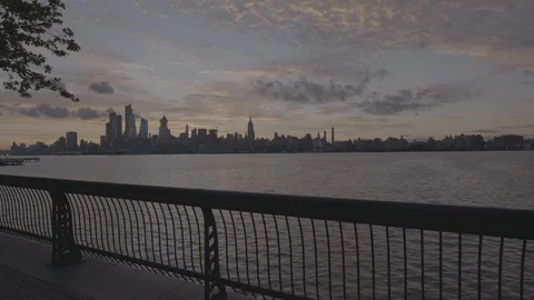 Tilt down to an extreme wide shot of Manhattan skyline. Stock Footage 95229873