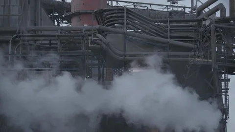 Tilt down from factory smoke to dump truck leaving factory Stock Footage 89945293