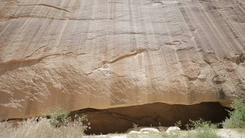 Tilt Down Flat Red Rock Wall Face to Hidden Crevice Stock Footage 121590790