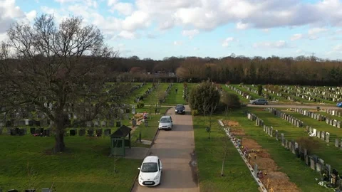 TILT DOWN FLY OVER A VEHICLE LEAVING A CEMETRY, EUROPE, LONDON, UK Stock-Footage 150286207