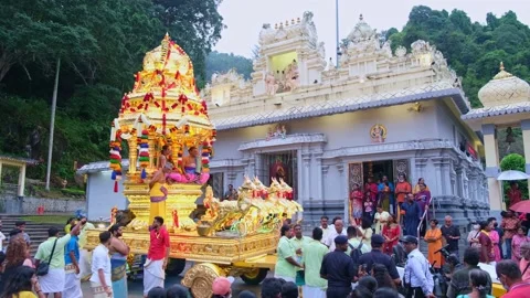 Tilt down gold chariot in front of Thanni Malai Murugan temple Stock Footage 235758162