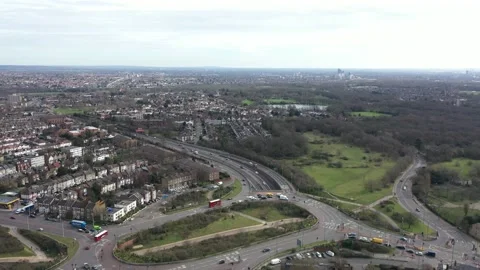 TILT DOWN HIGH ANGLE AERIAL REVEAL OF COMPLEX UK ROUNDABOUT ON HIGHWAY Stock-Footage 149902842