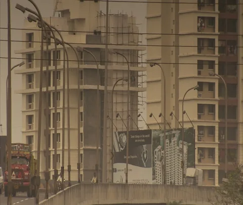 Tilt down from high-rise construction to oncoming traffic on highway. Stock Footage 86742531