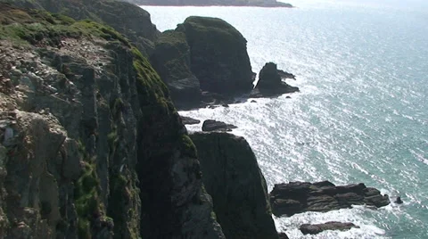 Tilt down on Holy Island cliffs, Anglesey Wales Stock Footage 33846469