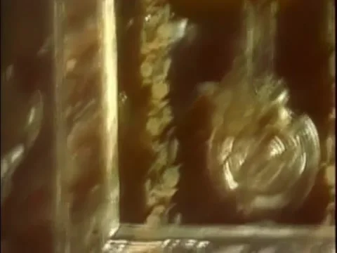 Tilt down image of cat resting by clock Stock Footage 260258204