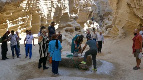 Tilt down inside Chahkooh Canyon in Qeshm Island Iran to crowd of visitors Stock Footage 111668547