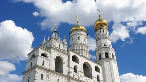 Tilt down on Ivan the Great Bell Tower cathedral inside Moscow Kremlin blue sky Stock Footage 99257540