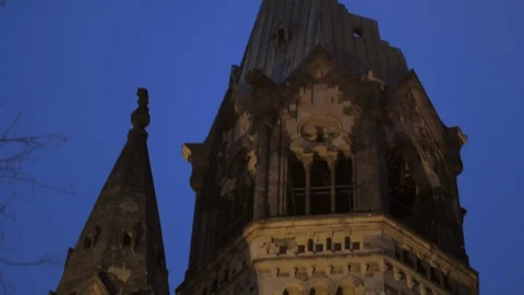 Tilt down of Kaiser Wilhelm Memorial Church in the evening in Berlin Stock Footage 130121688