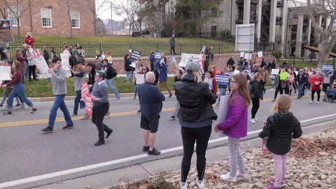 Tilt Down Kids Protesting And Marching Gun Violence Walking Passed Camera Wide Video stock 89006249