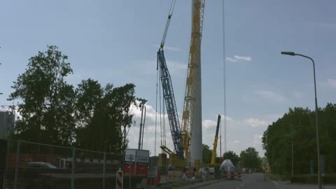 Tilt down lattice boom crawler crane monopile windturbine Stock Footage 245191881