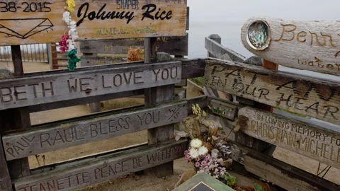 Tilt down on memorials for fallen Surfers at Lighthouse Point, Santa Cruz Stock Footage 93811249