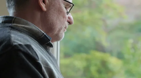 Tilt down, middle aged man at home using tablet computer near window Stock Footage 33212626