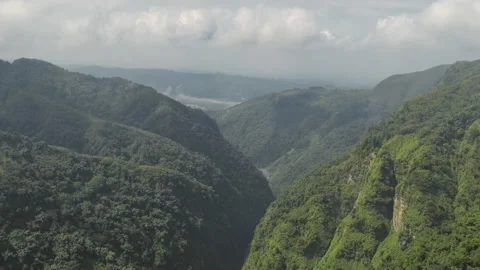 Tilt down move. Aerial view on green valley with fast moving clouds Stock Footage 172254641