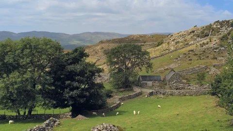 Tilt down move. Shadow of clouds move fast, old welsh stone building in mount Video stock 94259788