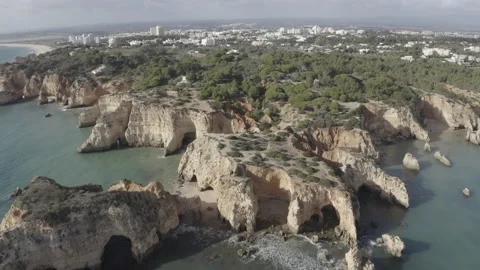 Tilt Down Orbit Aerial Of Cliffs By The Sea At Algarve Portimao 4K Stock Footage 167244278