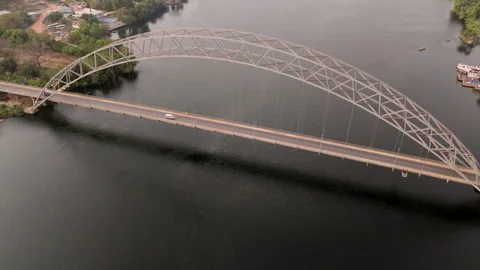 Tilt down over Adomi Bridge as vans pass over Stock Footage 299747434