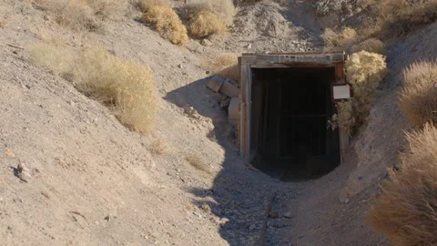 Tilt Down Over Nevada Desert to Reveal Mine Entrance with Ore Cart Track Stock-Footage 144657046