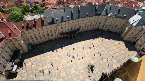 Tilt Down Over St. Vitus Cathedral and Prague Castle Courtyard with Cityscape Stock Footage 346965192