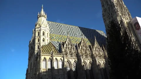 Tilt down from the peak of St. Stephens Cathedral to crowds of tourists on Stock Footage 230124790