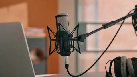 Tilt down on professional recording setup with microphone and computer on desk Video stock 218475696