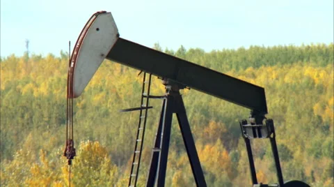 Tilt down of pump jacks working in a field for oil and gas industry. Stock Footage 59851685