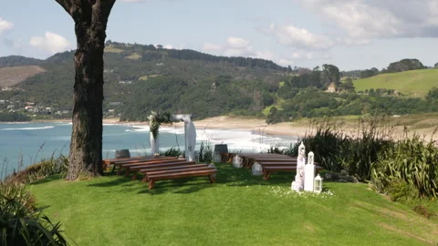 Tilt down to reveal stunning beachside wedding venue Stock Footage 241406400