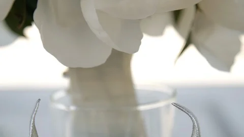 Tilt down ring in between silver high heels close up Stock Footage 112140632