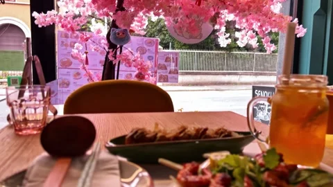 Tilt Down from Sakura Decor to Asian Meal Plate Vídeo Stock 326288101