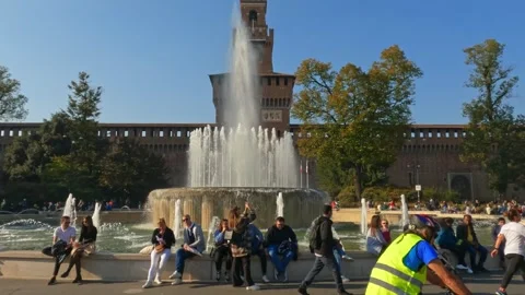 Tilt-down of sforza castle with tourists and bicycle Stock Footage 281179196